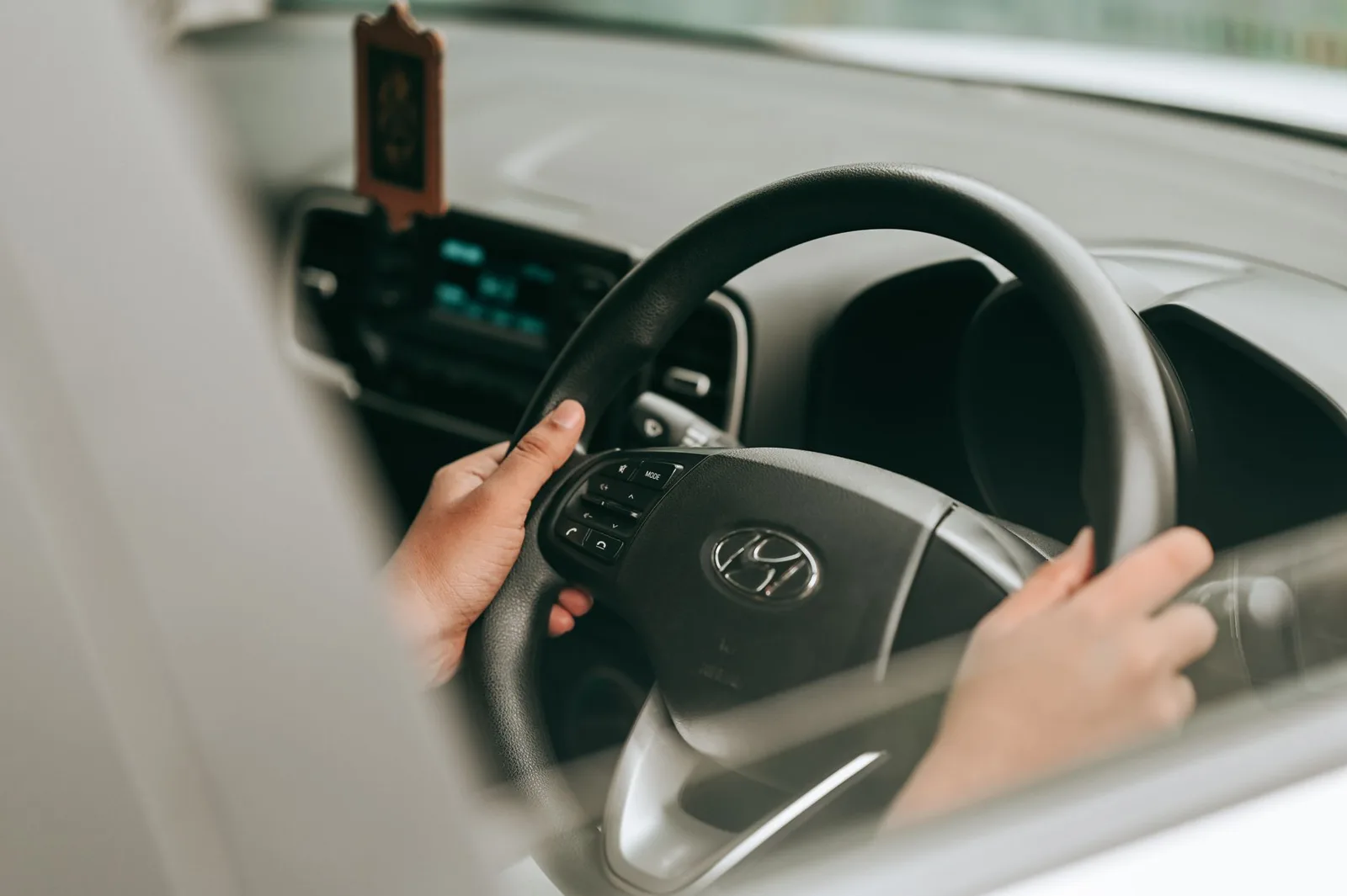Driver at the wheel inside a car cabin