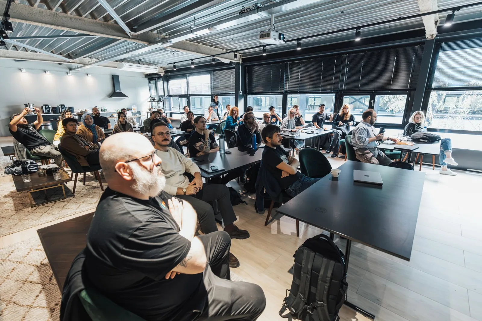 People around a conference table in a closed meeting room