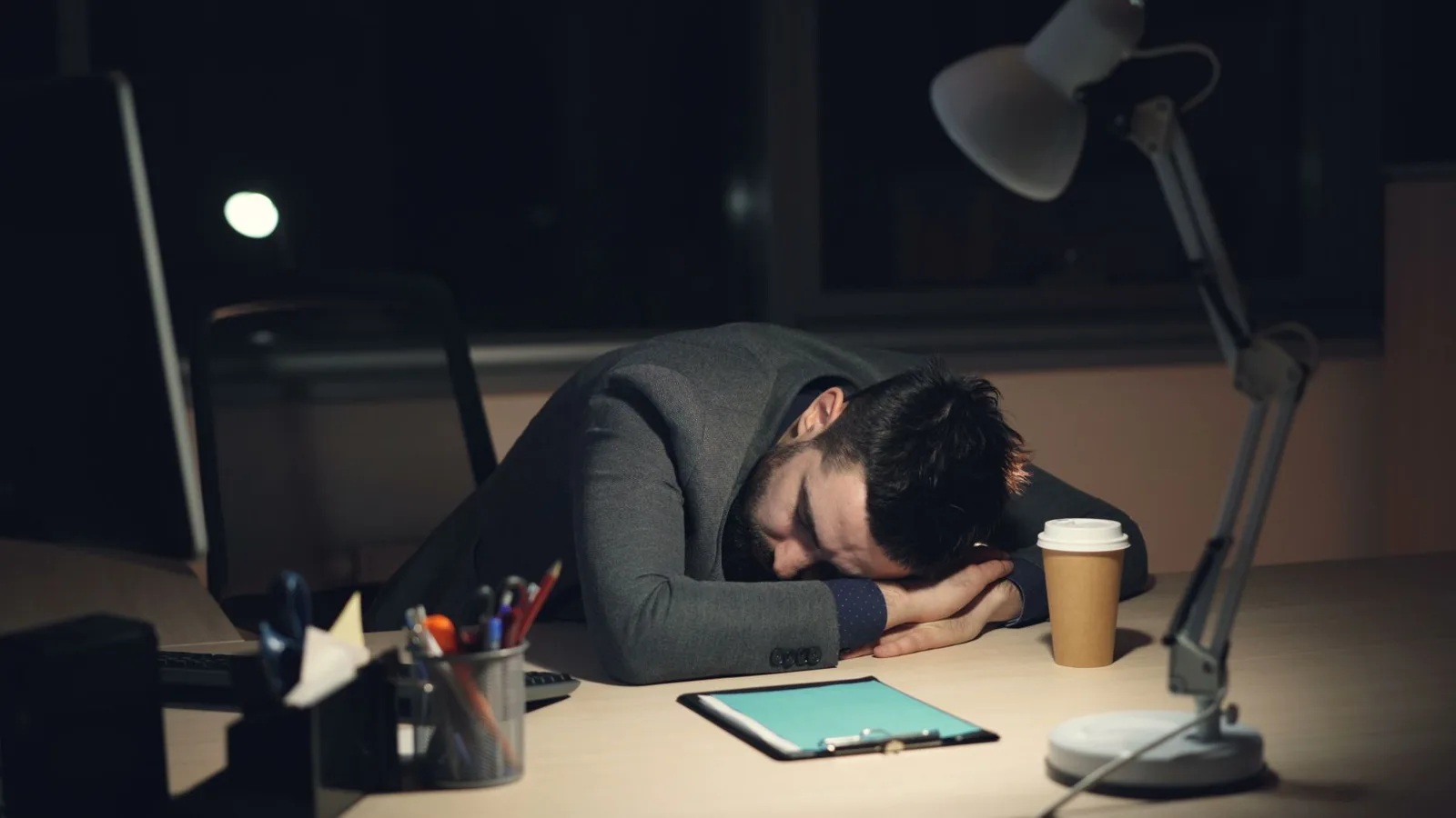 Tired office worker at a computer desk